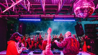 John Talabot, Yu Su and Leon Vynehall laughing together behind the decks of the Visionaire stage at Rally Festival