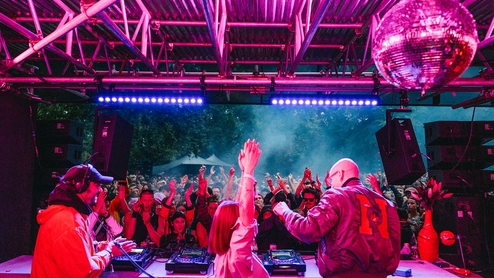 John Talabot, Yu Su and Leon Vynehall laughing together behind the decks of the Visionaire stage at Rally Festival