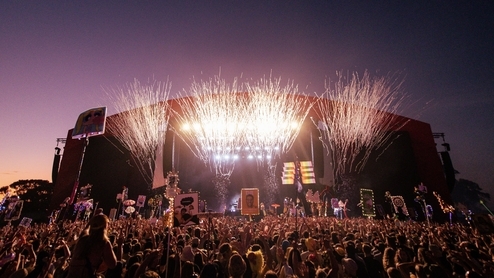 Photo of the mainstage at Beyond The Valley festival 2022 with a bright orange sunset