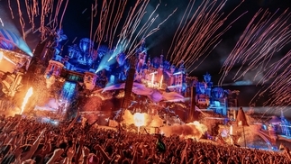 Photo of a busy main stage at Tomorrowland 2023 with colourful lights