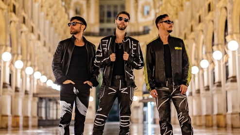 Photo of Meduza's Luca De Gregorio, Mattia Vitale and Simone Giani standing in a cathedral in 