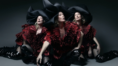 Photo of Roisin Murphy wearing an extravagant red dress and black hat