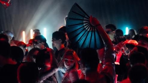 Photo taken of the crowd at Kyiv's Strichka Festival. One dancer is waving a blue fan above their head