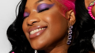 UNIIQU3 poses wearing purple eyeshadow