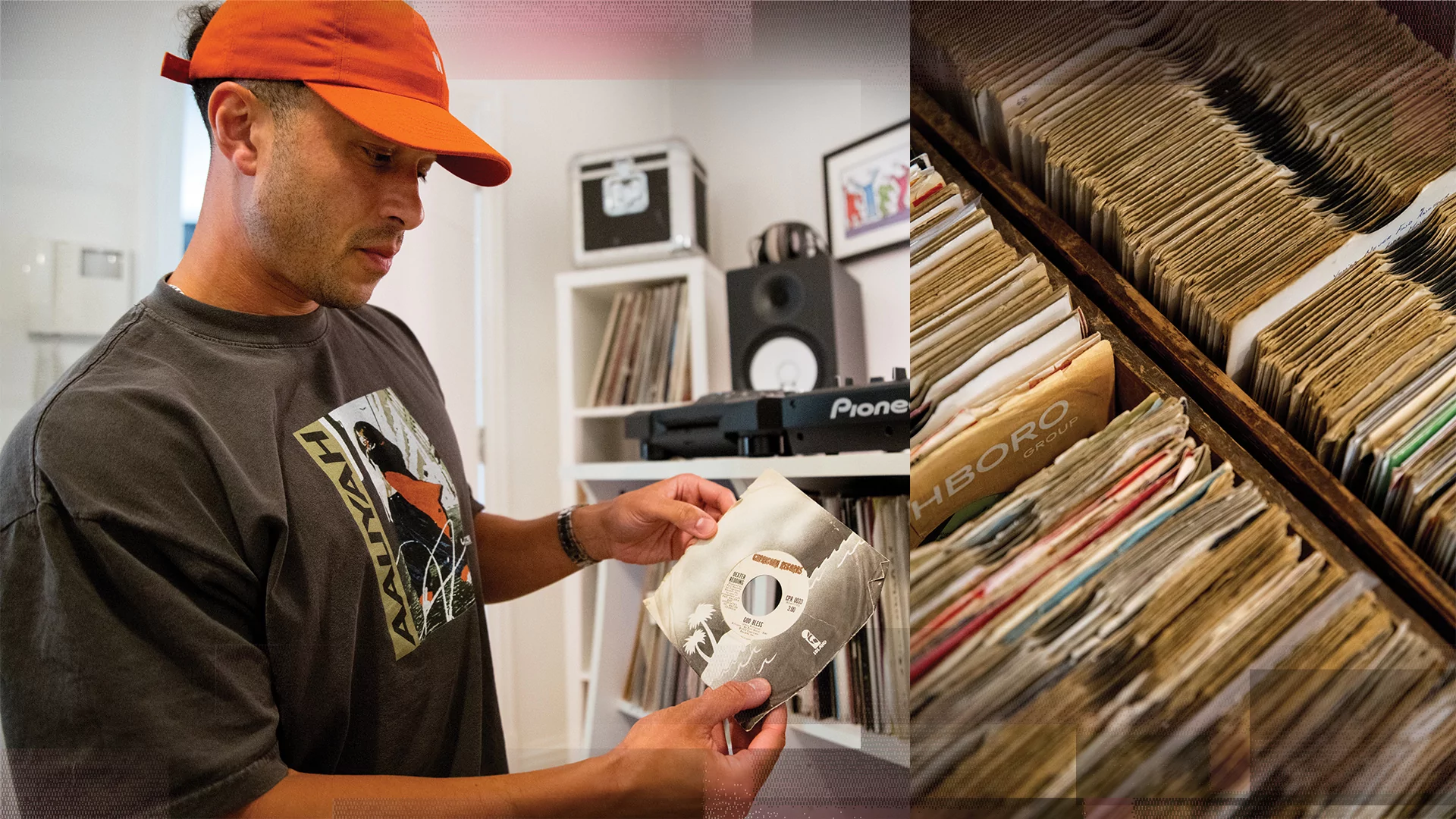 Photo of Melvo Baptise holding a record and wearing a red cap