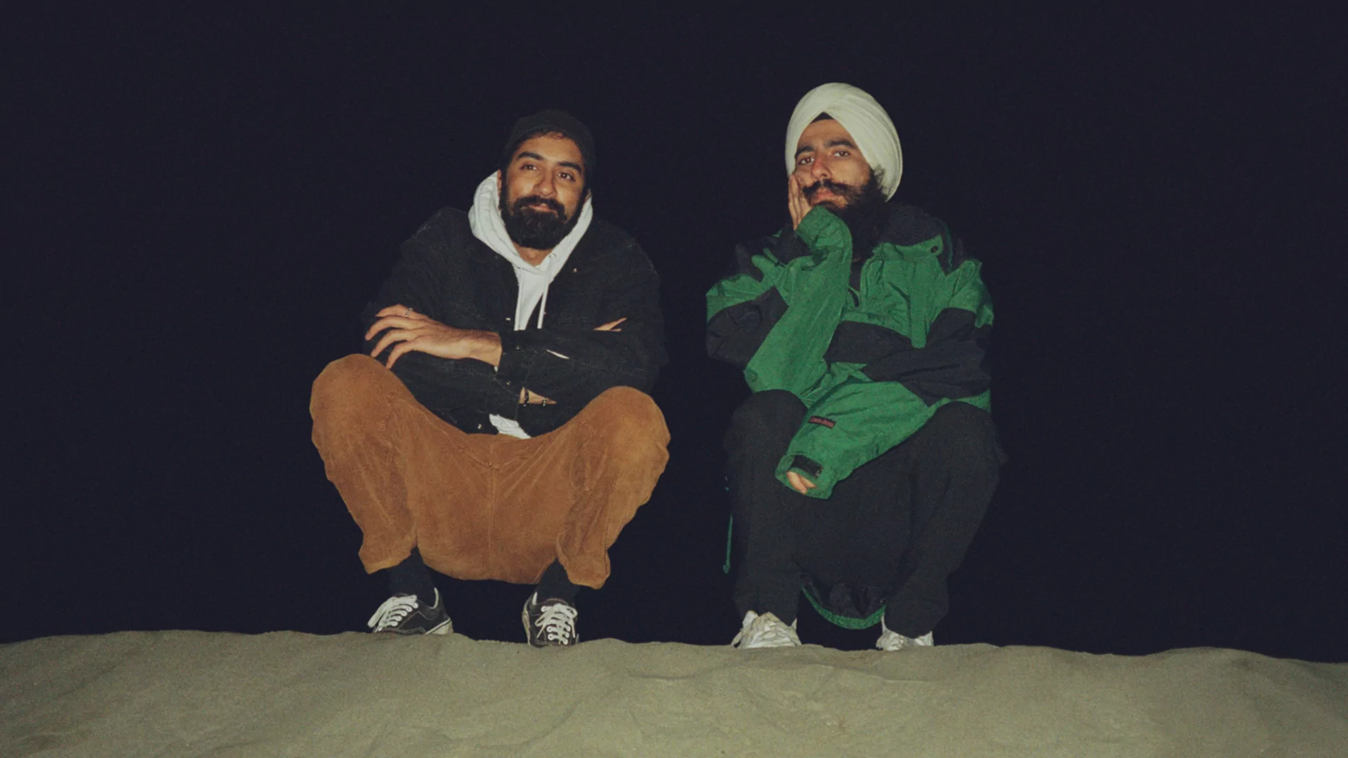 Press shot of Baalti crouching in the sand